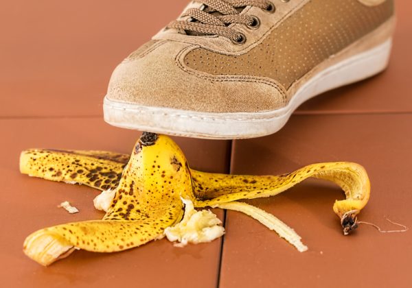 Renters insurance: a man slips on a banana peel. 